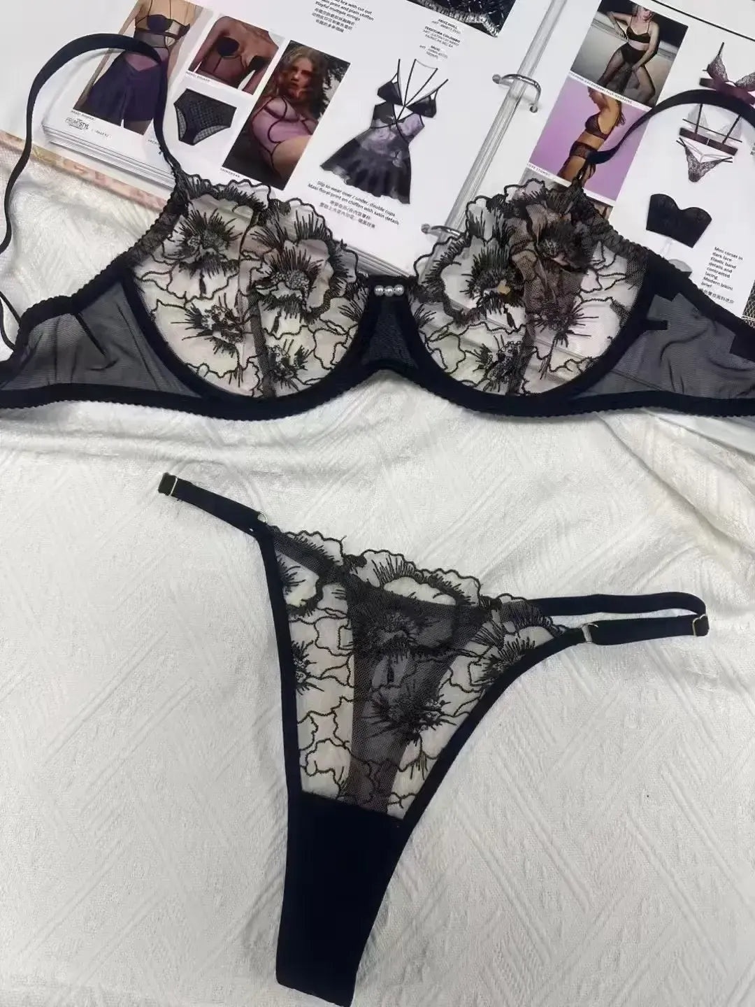 Back of black embroidered mesh lingerie set with elegant gold thread pattern adding high-end appeal.