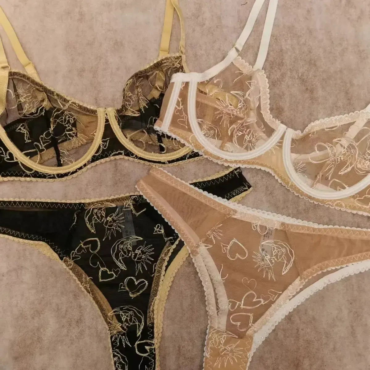 Close-up of Nude Lace Women Underwear Set and Black Gold corset set materials showing sheer lace and celestial embroidery.
