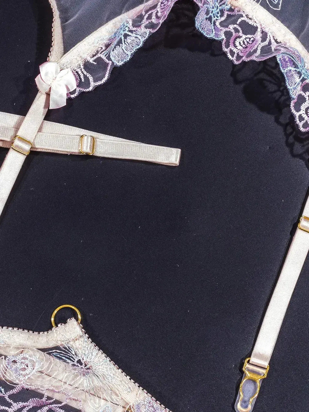 Purple lace lingerie with adjustable elastic straps.